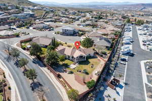 Aerial view of property's location featuring a mountainous background and nearby suburban area