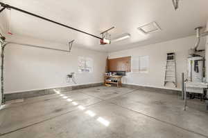 Garage featuring a workshop area and gas water heater