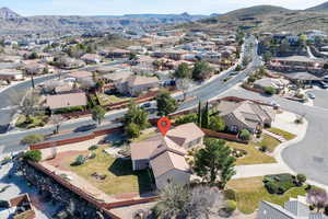 Aerial overview of property's location featuring a mountain backdrop and nearby suburban area