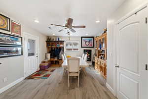 Dining area with a ceiling fan, light wood-type flooring, and recessed lighting