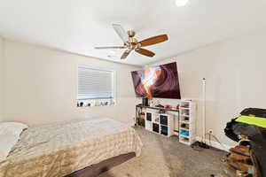 Bedroom featuring light carpet and a ceiling fan
