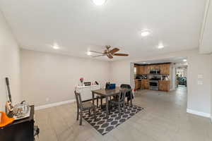Dining space with ceiling fan, recessed lighting, and wood tiled floors