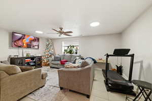 Living room with a ceiling fan and baseboards
