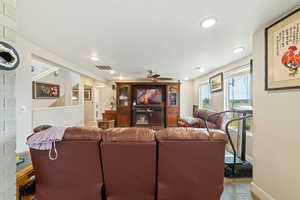 Living area with ceiling fan, light wood-type flooring, and recessed lighting
