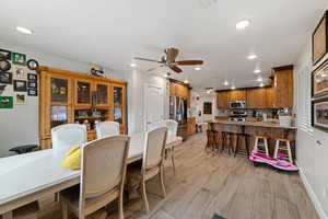 Dining room featuring light wood-style floors, a ceiling fan, and recessed lighting