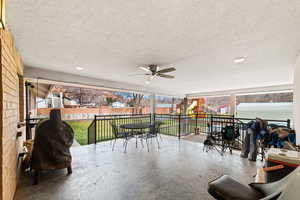 View of patio / terrace featuring outdoor dining space, a playground, a ceiling fan, and a residential view