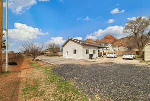 View of side of property with stucco siding, a mountain view, and a residential view