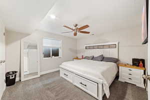 Carpeted bedroom featuring ceiling fan and baseboards
