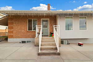 Entrance to property featuring brick siding