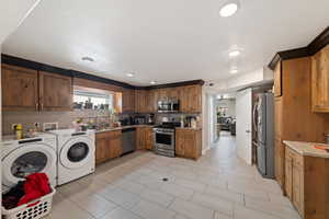 Kitchen with stainless steel appliances, healthy amount of natural light, wood finish cabinets, tasteful backsplash, and recessed lighting