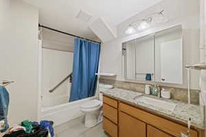 Bathroom with vanity and shower / tub combo with curtain