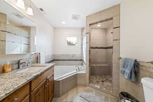 Full bath with vanity, a bath, and a tile shower