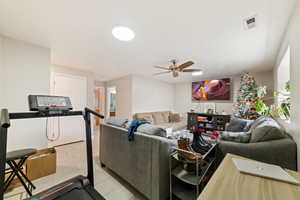 Living area featuring light wood-type flooring and a ceiling fan