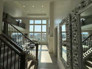 Entrance foyer with recessed lighting, hardwood / wood-style floors, and a raised ceiling