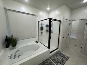 Bathroom with a garden tub, a stall shower, and recessed lighting