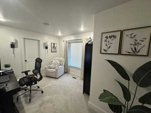 Office area featuring baseboards and light colored carpet