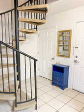 Stairs featuring tile patterned flooring