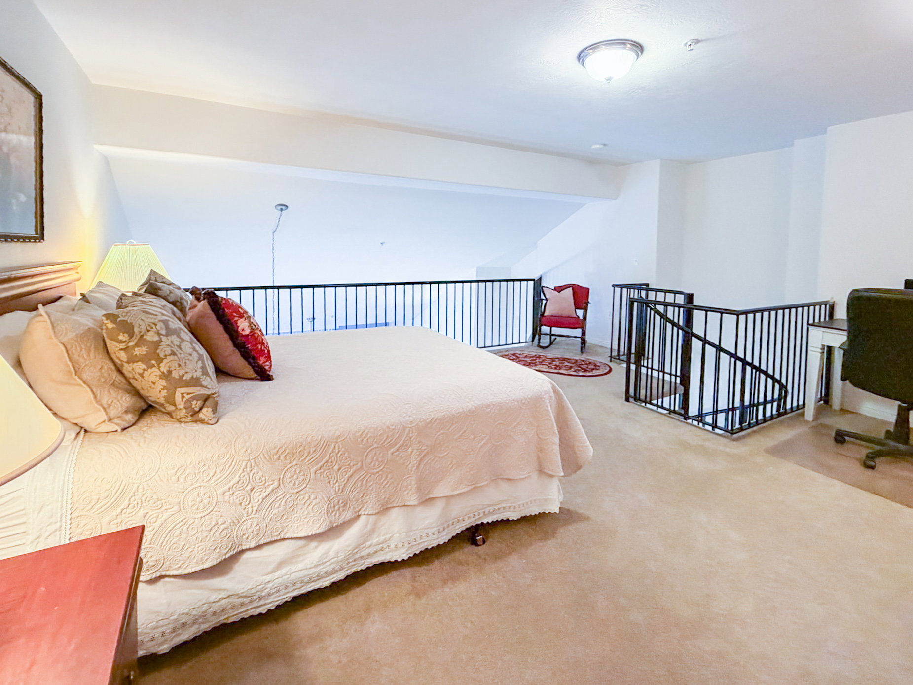 Bedroom featuring light carpet