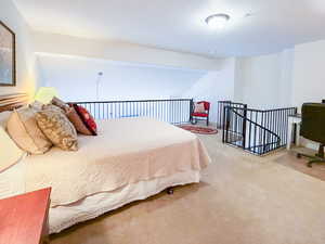 Bedroom featuring light carpet