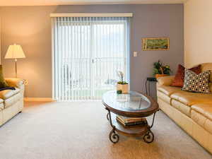 Carpeted living area with baseboards