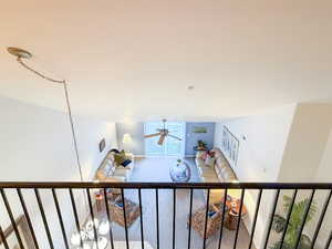 Staircase featuring ceiling fan and carpet floors
