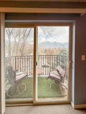 Doorway to outside with carpet flooring and a mountain view