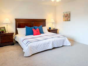 Bedroom featuring light carpet and a ceiling fan