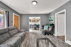 Living room featuring light wood-style flooring and baseboards