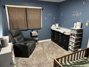 Bedroom with light colored carpet and baseboards