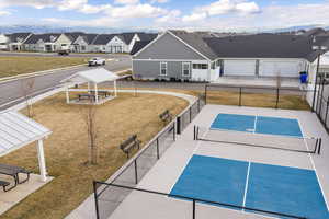 View of community with a patio area, a residential view, and a tennis court