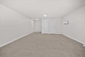Unfurnished bedroom featuring light carpet and baseboards