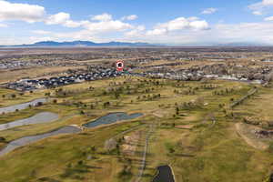 Aerial perspective of suburban area featuring a water and mountain view and a local golf course