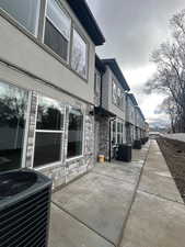 View of side of property with stone siding, stucco siding, and a residential view
