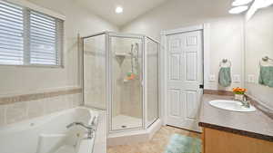 Full bath with vanity, a stall shower, a tub with jets, light tile patterned flooring, and recessed lighting