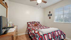 Bedroom with light carpet and ceiling fan