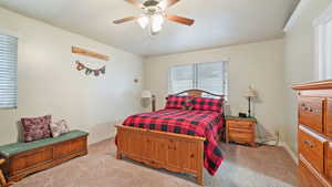 Bedroom with light colored carpet and ceiling fan