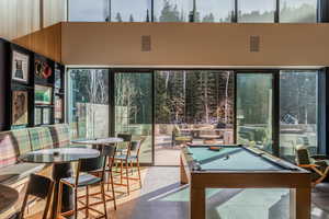 Rec room featuring billiards, healthy amount of natural light, and a high ceiling