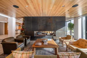 Building lobby featuring wooden ceiling, recessed lighting, and expansive windows