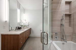 Full bathroom with double vanity, a garden tub, a stall shower, and tile patterned flooring