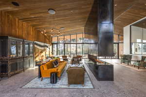 Common area with a high wooden ceiling and wood walls