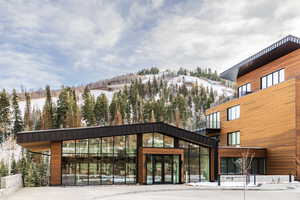 Snow covered building with a mountain view