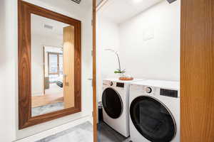 Laundry area featuring washing machine and clothes dryer