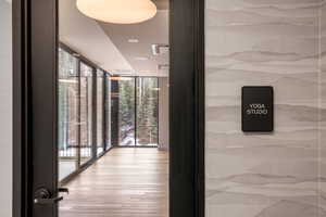 Corridor featuring expansive windows, wood finished floors, and recessed lighting