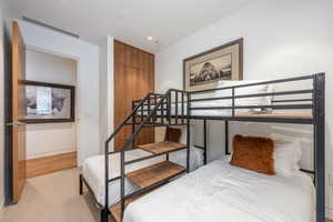 Bedroom featuring light carpet