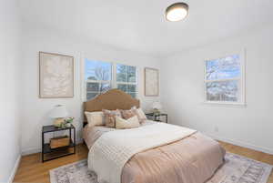 Bedroom featuring light wood-type flooring and baseboards