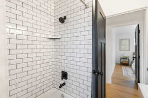Full bathroom featuring shower / bathtub combination and light wood-style floors
