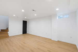 Basement featuring recessed lighting and light wood-style floors