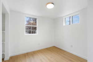 Unfurnished room with baseboards and light wood-style flooring