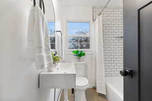 Bathroom featuring toilet and shower / tub combo