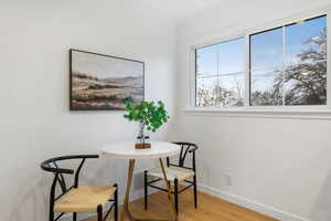 Dining area featuring light wood-style flooring and crown molding
